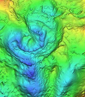 The buried Chicxulub crater shows a suggestive circular depression pattern in this 3-D gravity map in which different values are shown in different colors.